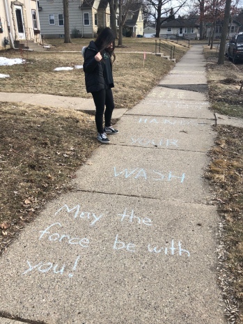 Lola takes in messages on the sidewalk.